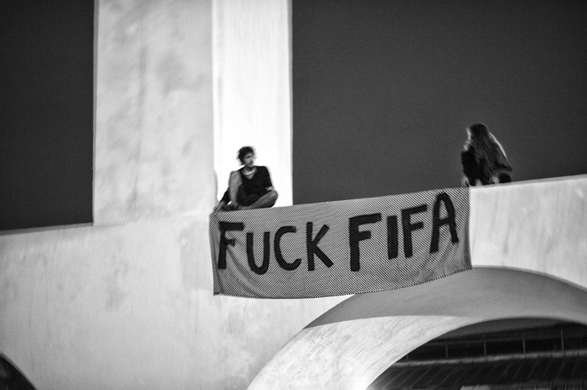 Two young guys climbing the famous Lapa arches to protest against FIFA.