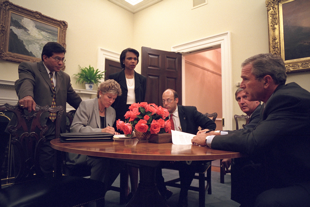 Working with his senior staff, President George W. Bush goes over the speech that he will deliver to the nation the evening of Tuesday, Sept. 11, 2001, from the Oval Office. Pictured with the President from left to right are: White House Counsel Alberto Gonzales, Counselor Karen Hughes, National Security Advisor Dr. Condoleezza Rice, Press Secretary Ari Fleischer and Chief of Staff Andy Card. Photo by Paul Morse, Courtesy of the George W. Bush Presidential Library