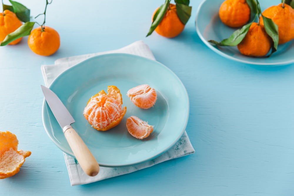 Peeled oranges on a plate